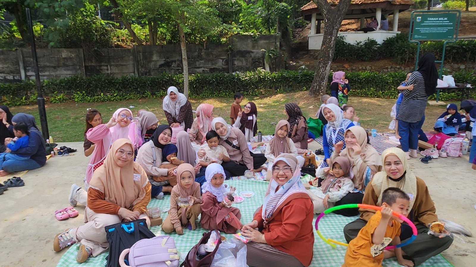 Anak-anak dan keluarga berfoto bersama di area kegiatan